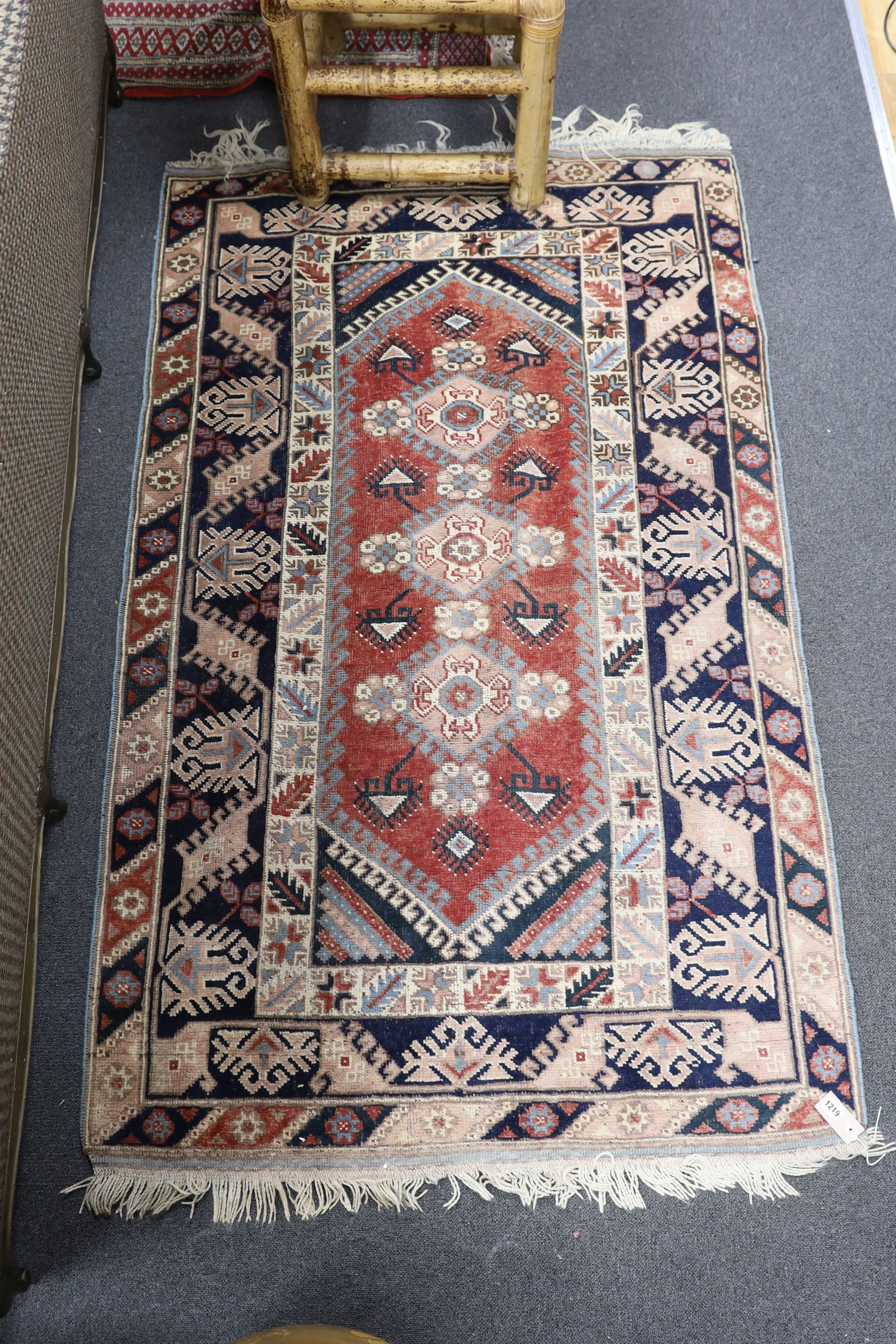 A Caucasian red ground rug and a Bokhara runner, rug 180 x 120 cms